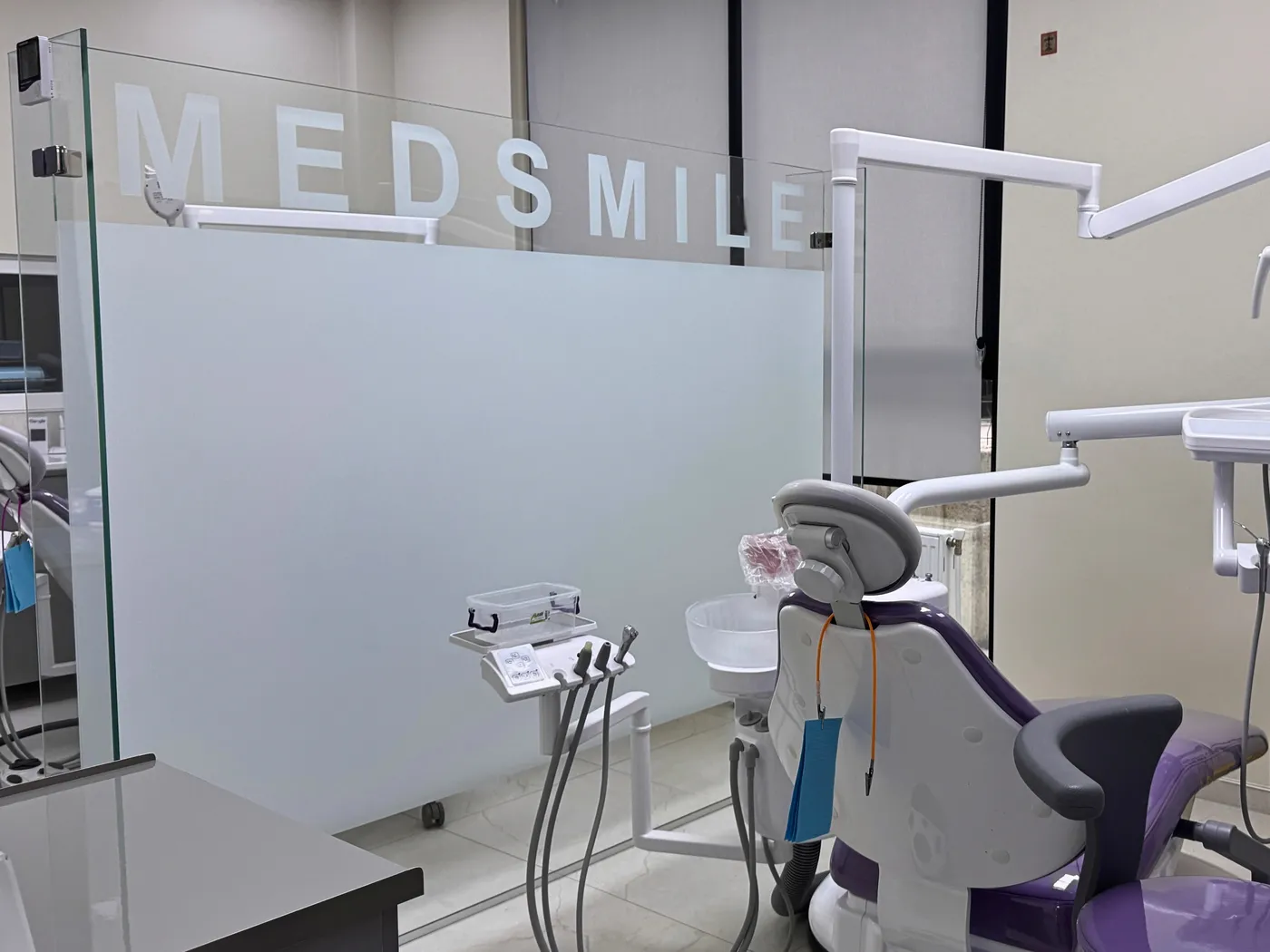 A treatment room with the clinic's branded glass partition
